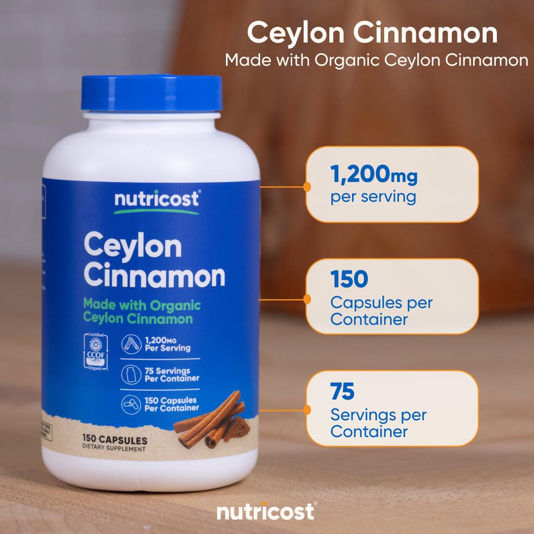 Nutricost Cinnamon bottle on a kitchen counter with a glass of water.
