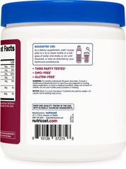 Pouring Nutricost Electrolyte Complex into a glass during a workout session.