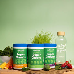 Nutricost Organic Super Greens Powder dissolved in a glass with vibrant color
