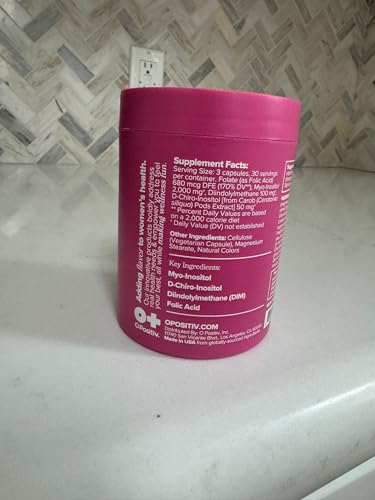 Lifestyle scene of a woman taking FLO capsules as part of a routine.
