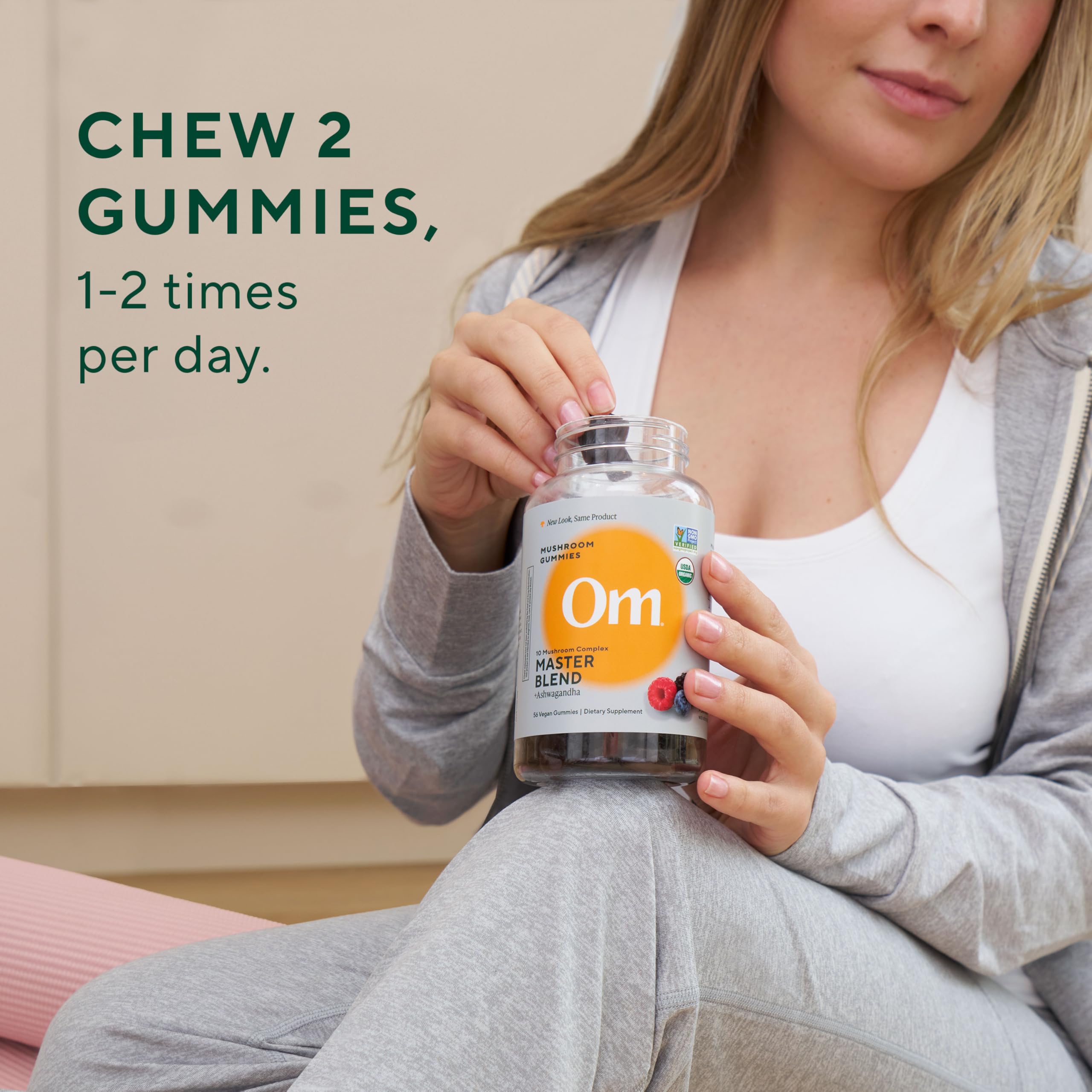Gummies on a spoon with water, illustrating convenient daily intake by OM Master Blend.