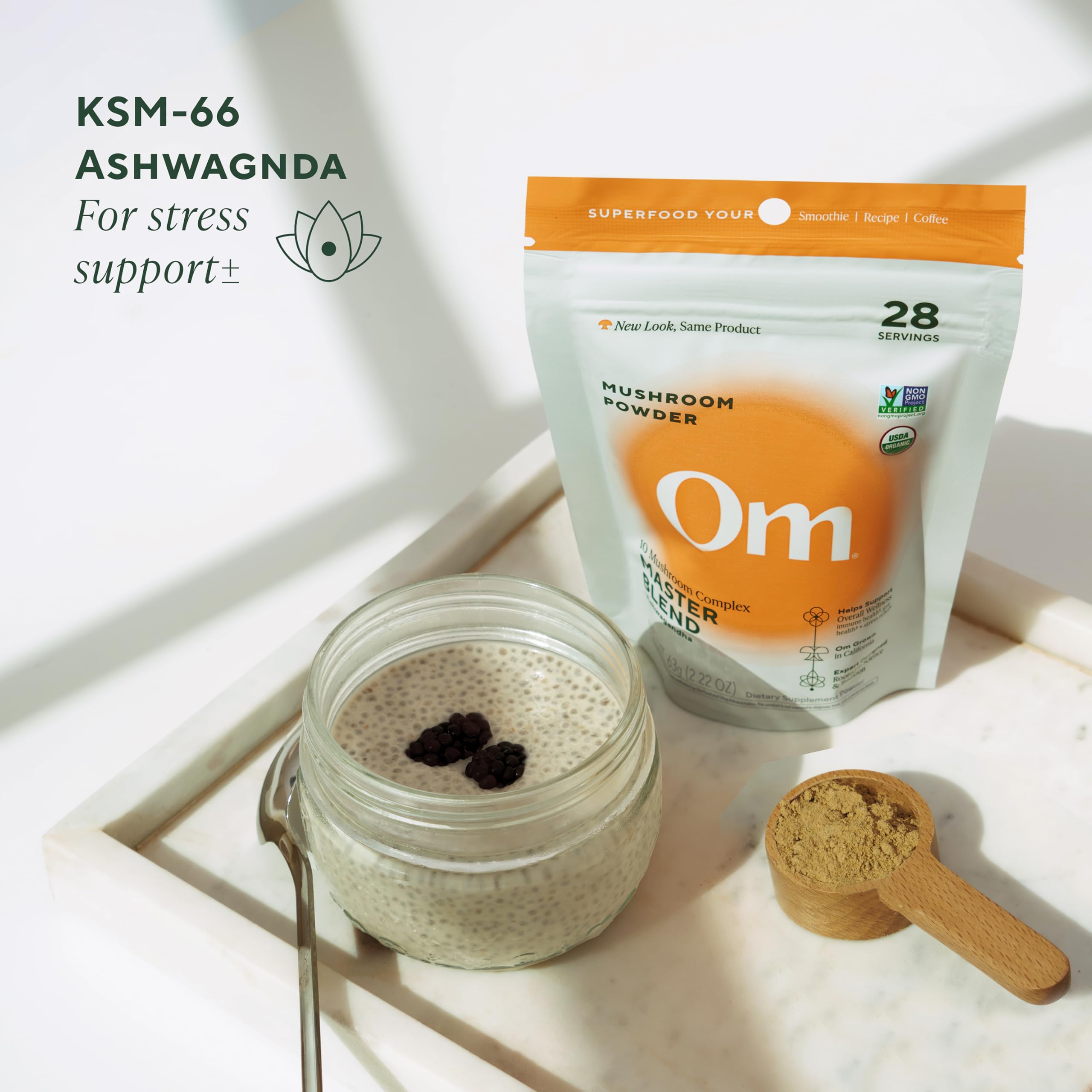 Spoon-dispense action with OM Mushrooms Master Blend supports precise dosing.