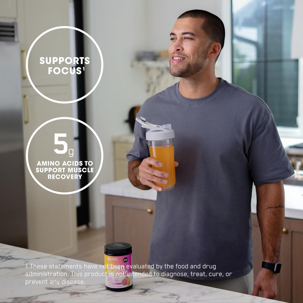 Powder dissolving in water to make a Tropical Sunrise energy drink by Optimum Nutrition.