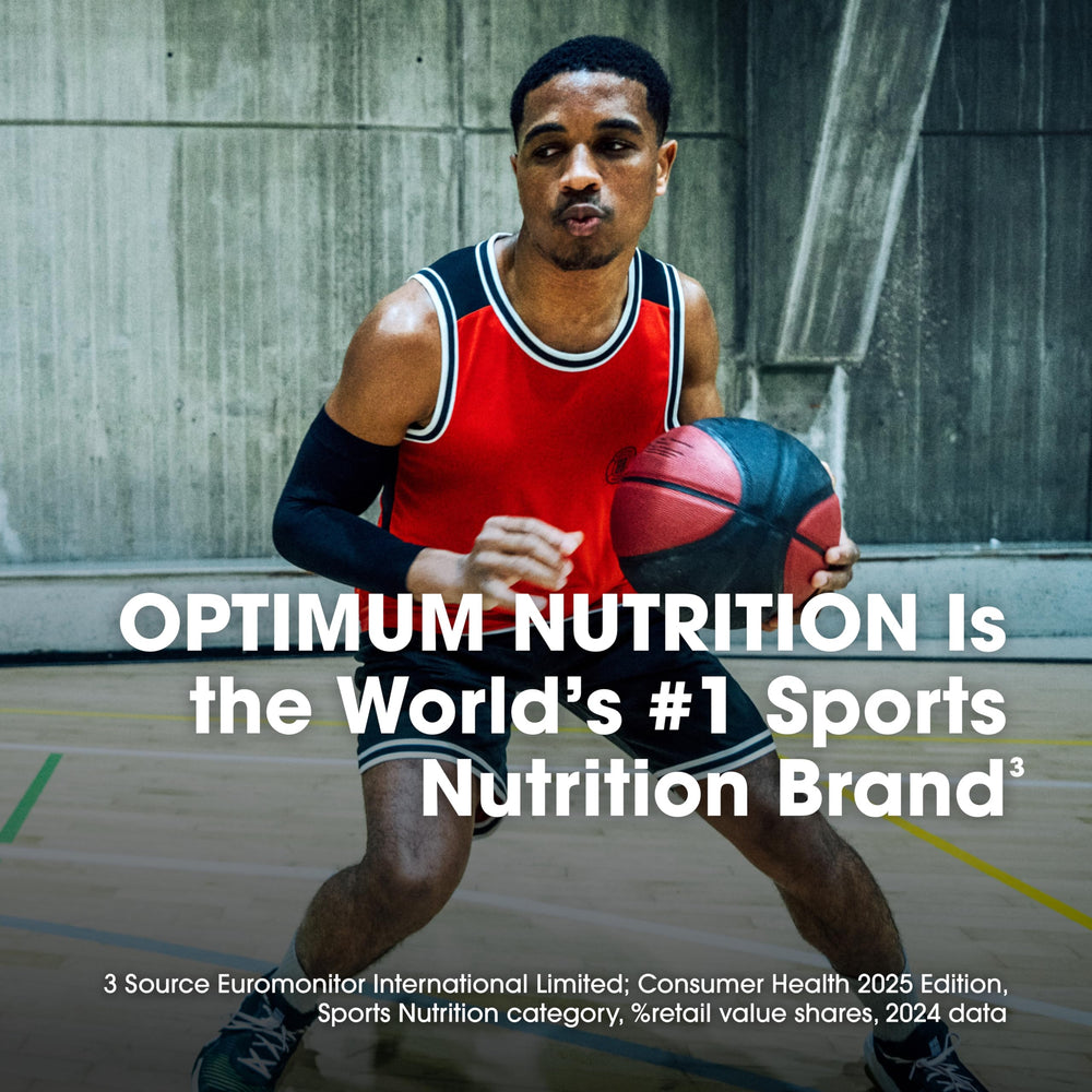 Optimum Nutrition powder being dispensed from jar for precise serving.