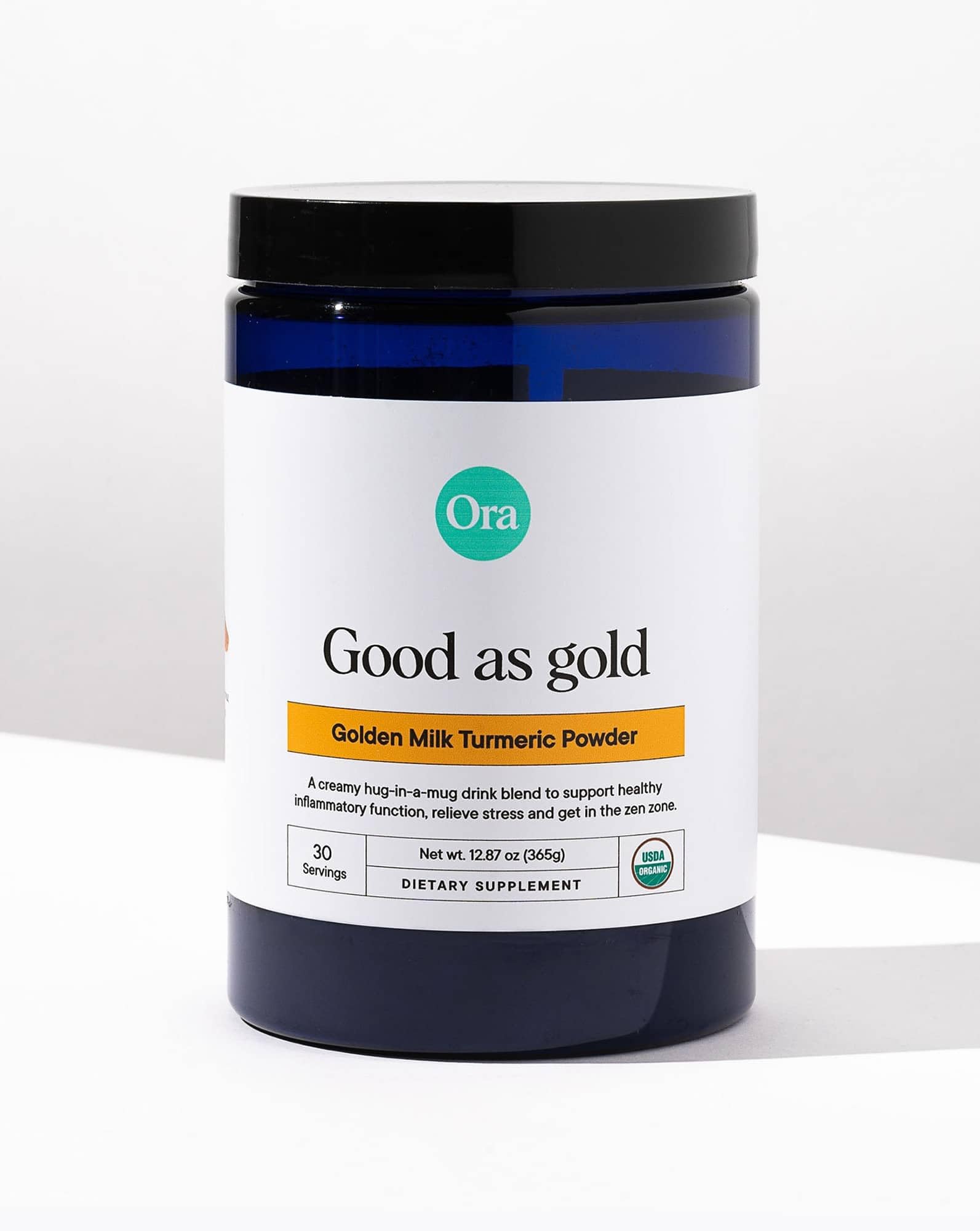Maple and vanilla flavor on Ora Organic Golden Milk Powder beside a steaming cup.