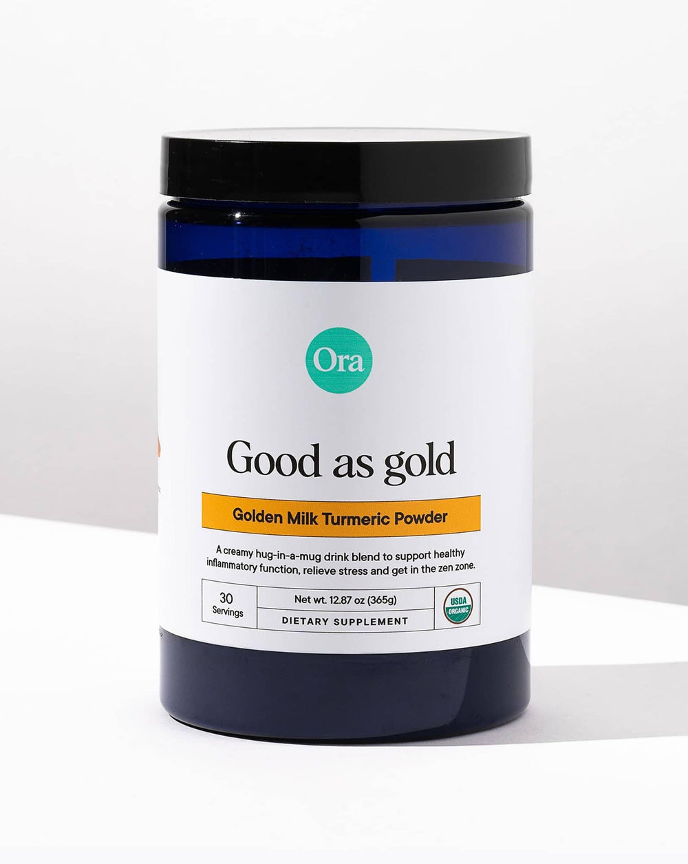 Maple and vanilla flavor on Ora Organic Golden Milk Powder beside a steaming cup.