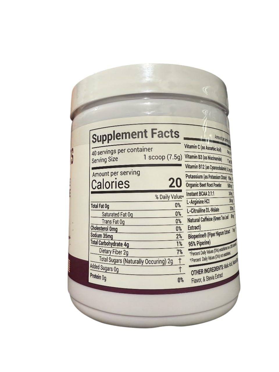 Peacock Max berry-colored beet powder in a clear glass with vibrant color