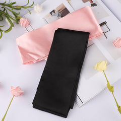 Pimoys satin eye-mask in pink blocking light for quick naps.