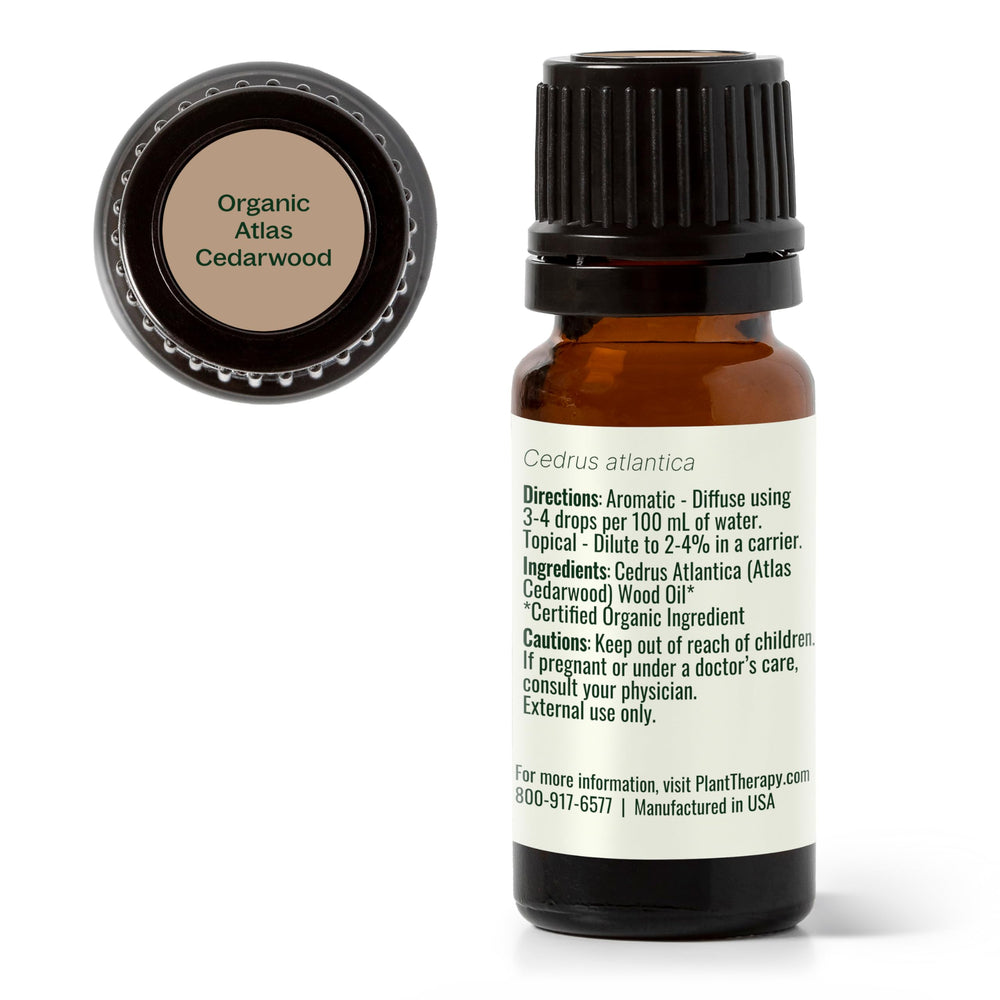 Plant Therapy Atlas Cedarwood bottle shown with rustic setting for authentic aromatherapy use.