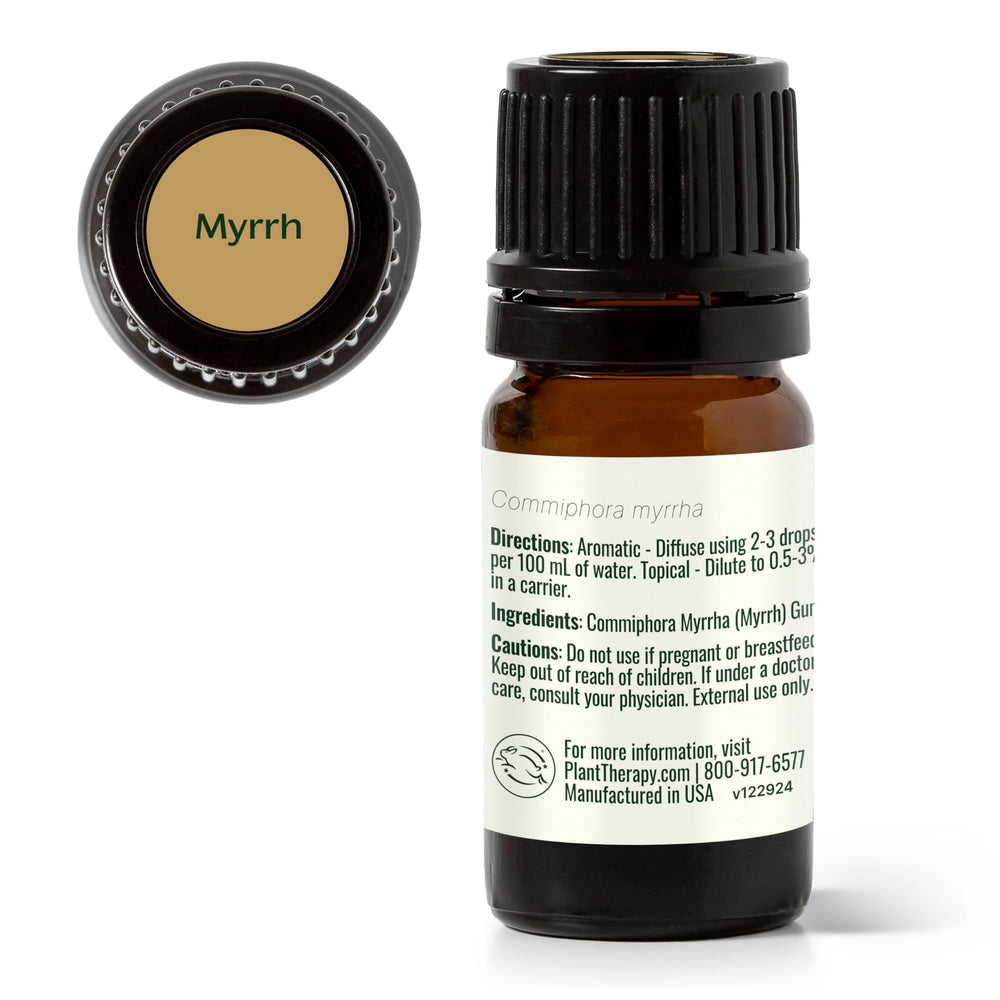 Plant Therapy Myrrh oil vial resting on a wooden surface