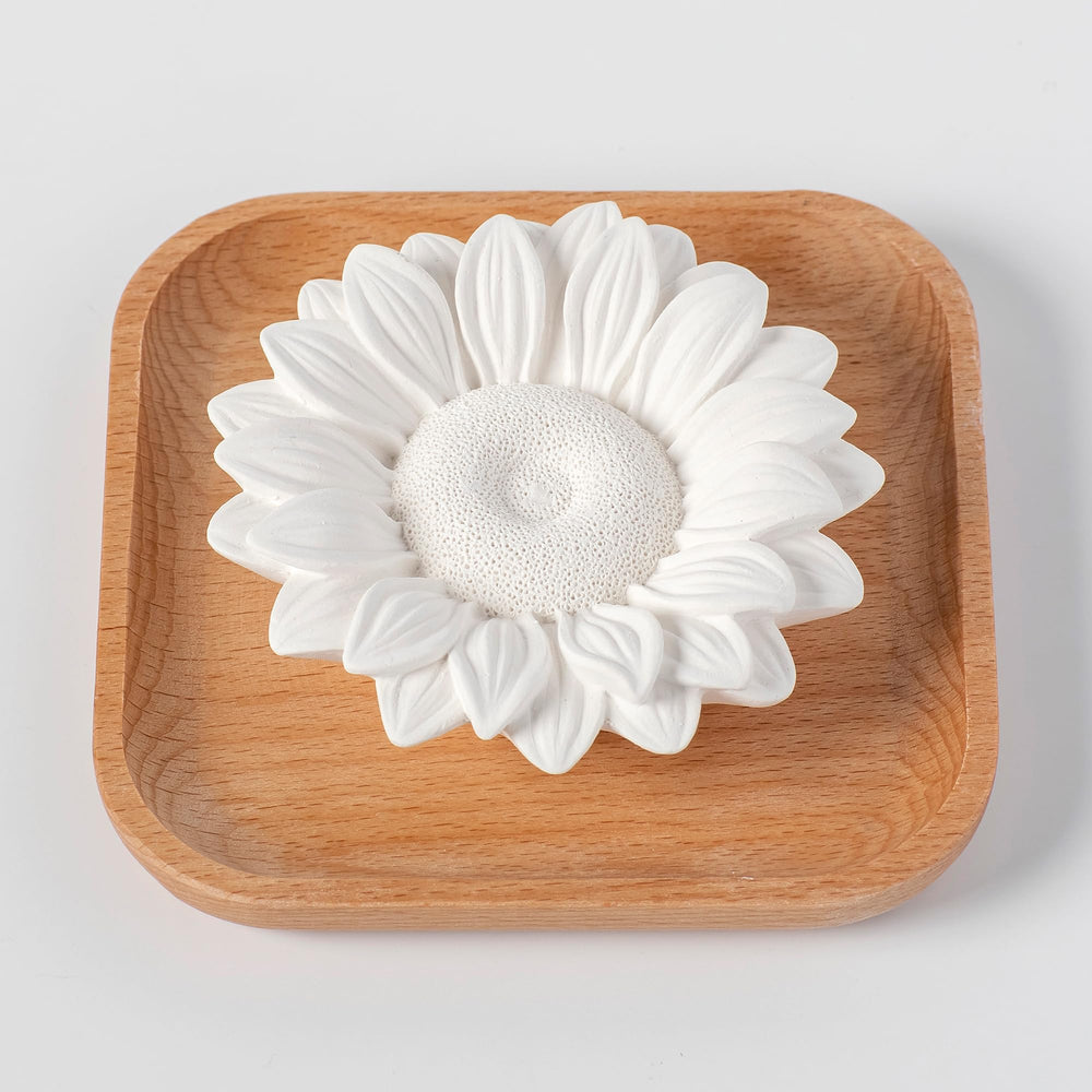 Portable sunflower diffuser fits travel bag for on-the-go scent.