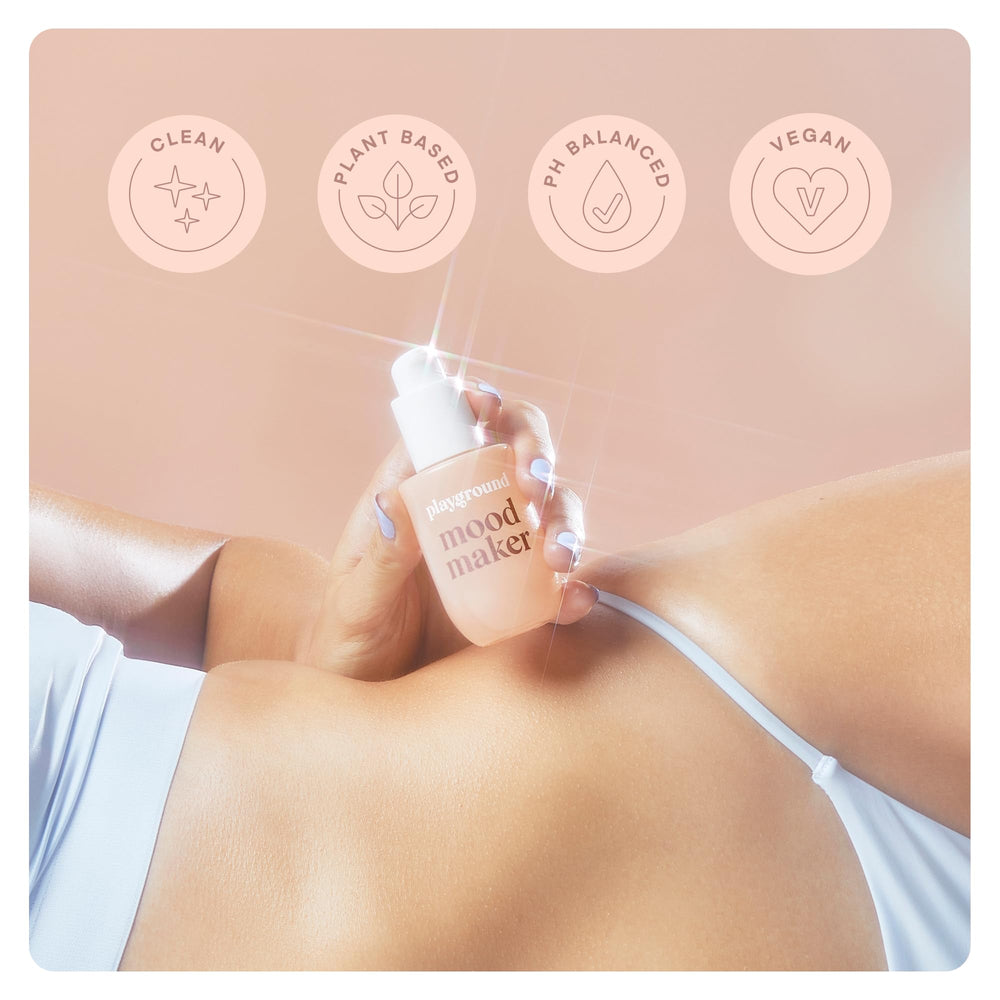 Playground Mood Maker Intimacy Oil bottle with drops emphasizes travel-friendly design.
