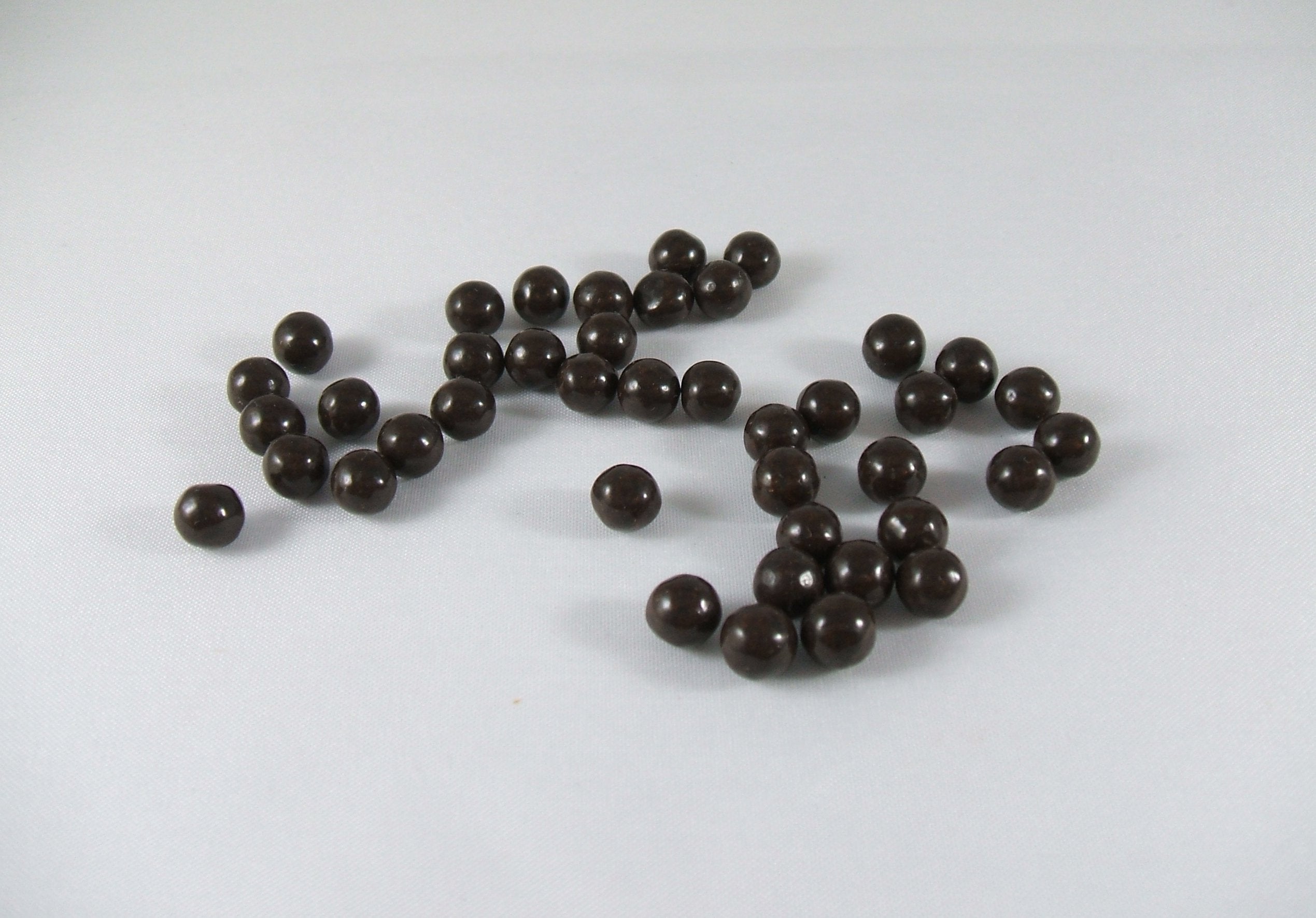 Close-up of Plum Flower teapills showing standard bottle design.