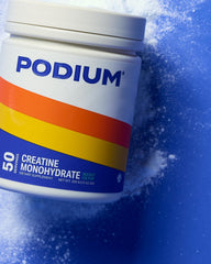 Podium Nutrition Rocket Ice Pop bottle beside a glass of prepared, refreshing shake.