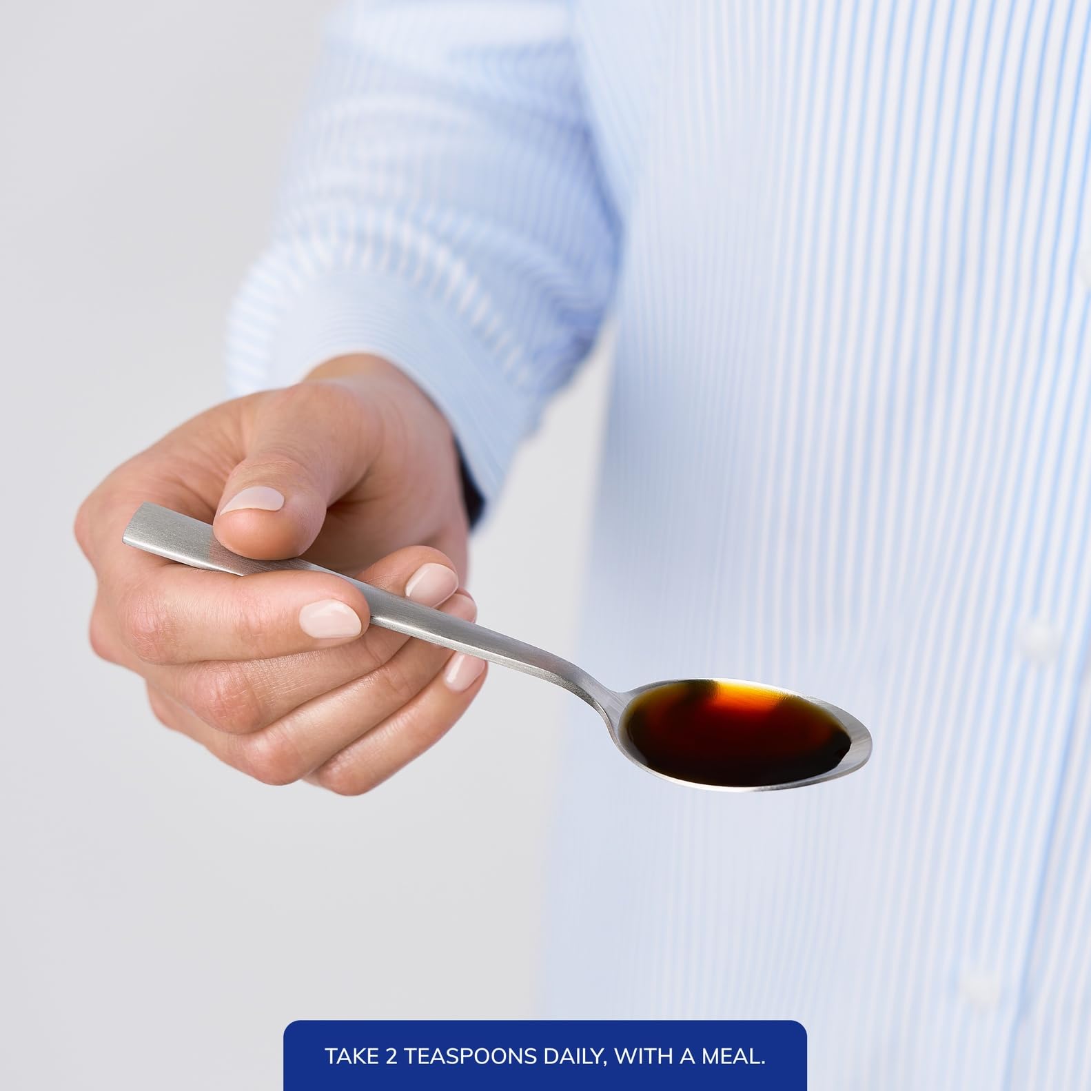 Measuring spoon with liquid magnesium glycinate for dose accuracy.