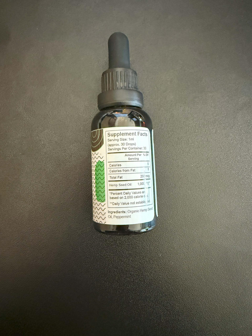 Pure Wellness glass bottle closeup showing clean label and dosage info