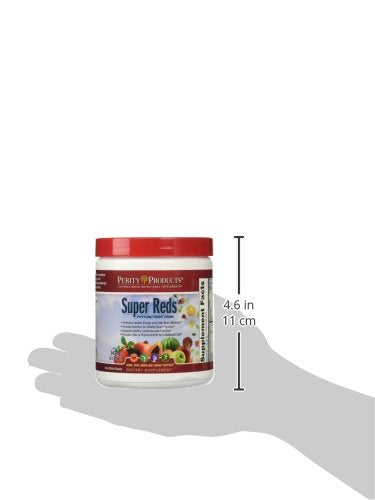 Purity Products Super Reds powder being stirred into water for a smoothie.