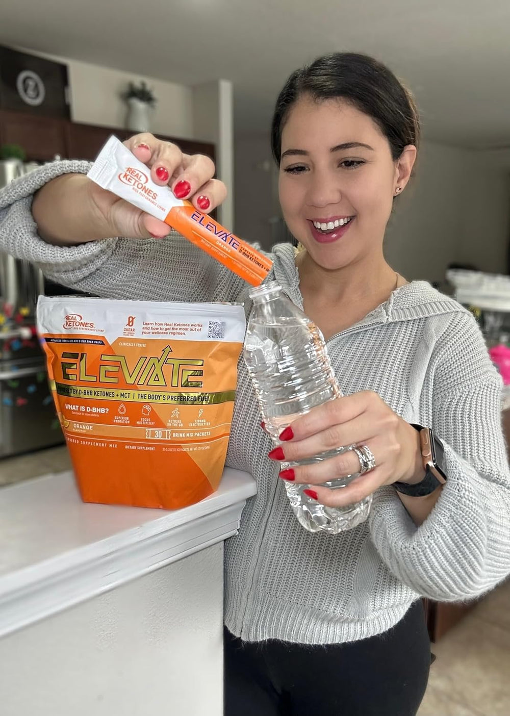 Real Ketones hydration mix in glass, orange drink.
