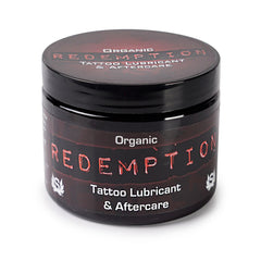 Redemption Tattoo Lubricant jar close-up for during tattoo sessions and aftercare hydration.