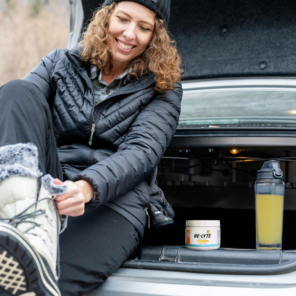 Glass of pineapple-orange Re-Lyte Immunity on counter