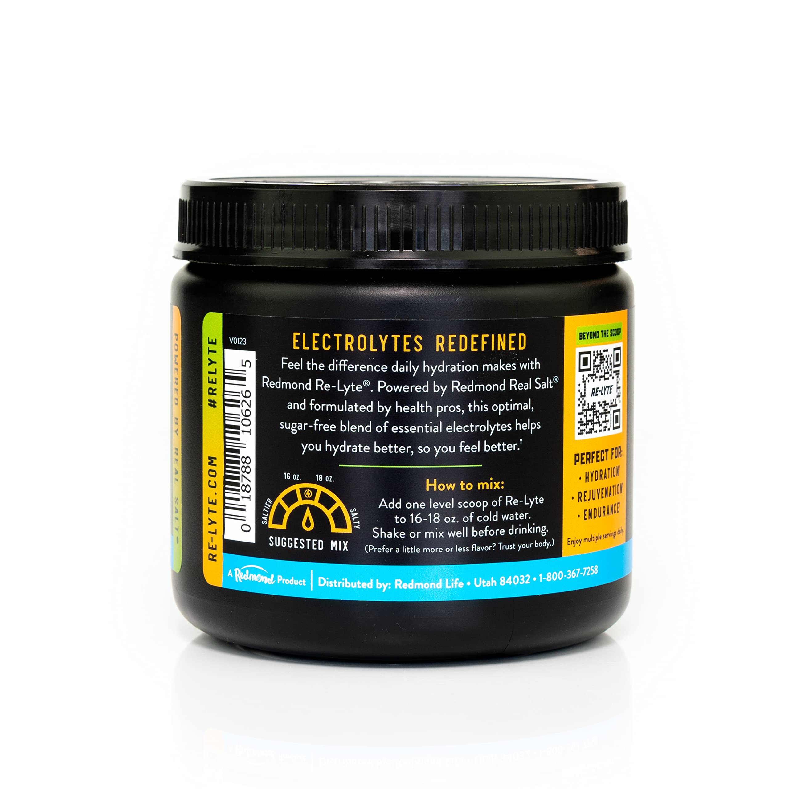 Scoop of Redmond Re-Lyte Mango dissolving in water for refreshing hydration.