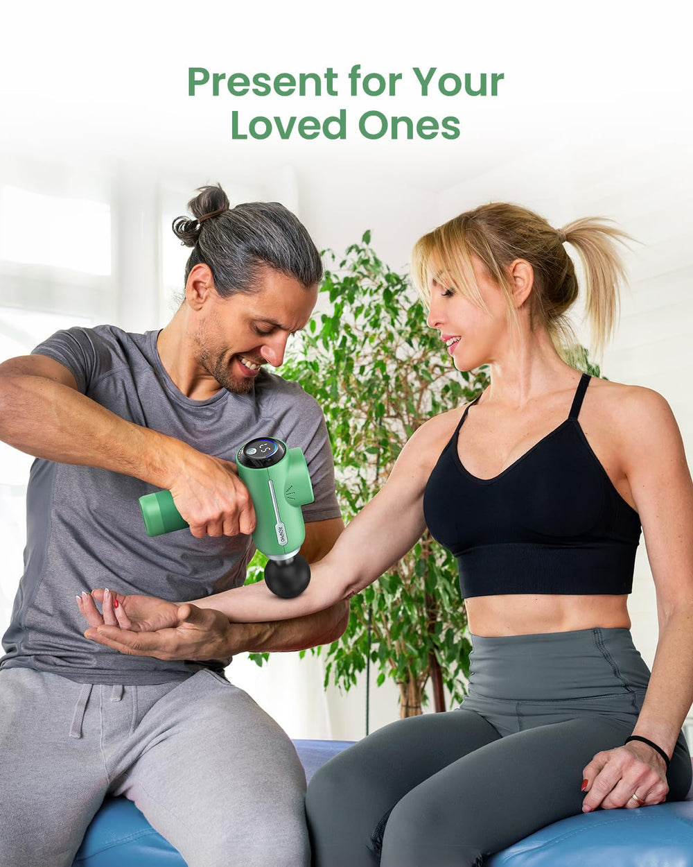 RENPHO massage gun using on back and neck for muscle relief.