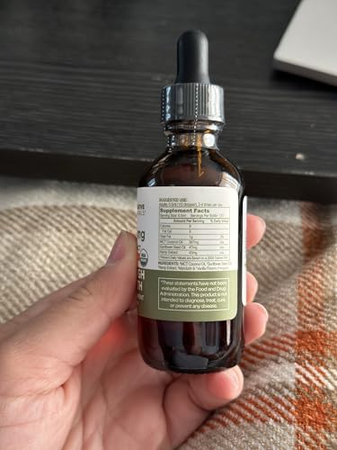 Restorative Botanicals dropper pour demonstrating precise dosing for consistency.