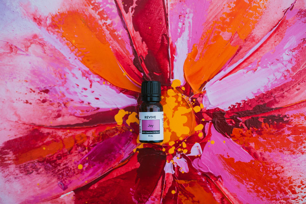REVIVEEO Joy essential oil blend during massage application with carrier oil