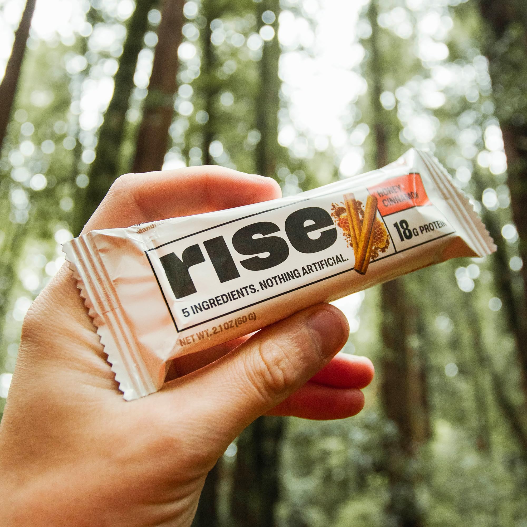 Rise honey cinnamon whey bar texture close-up showing natural ingredients.