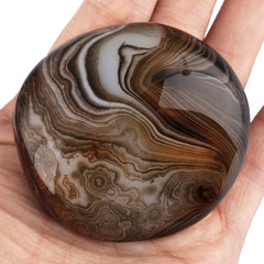 Rockcloud worry stone in hand, smooth surface for calming tactile use.