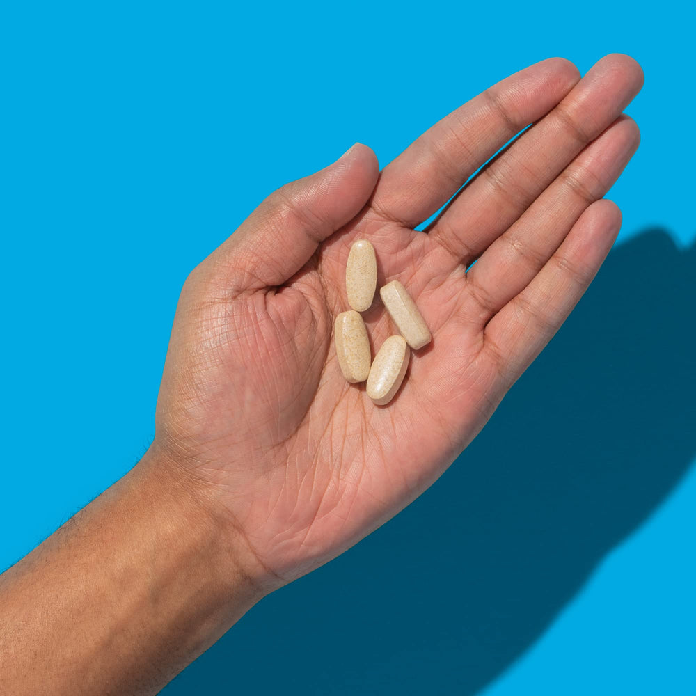 ROMAN Ro Testosterone Support tablets in hand for daily use