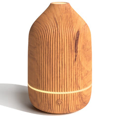 Salubrito essential oil diffuser wood grain close-up for a calming space.