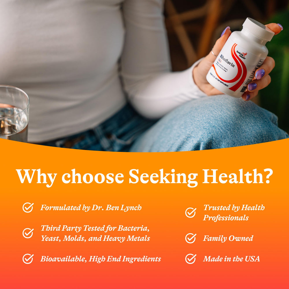 Seeking Health riboflavin vial in hand suggests easy portability for daily use.