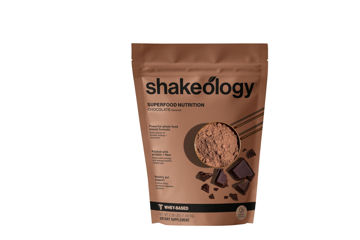 Shakeology 0g Added Sugar whey blend pours chocolate shake for a protein boost