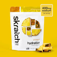 Skratch Labs Hydration Powder scoop beside a glass for quick hydration
