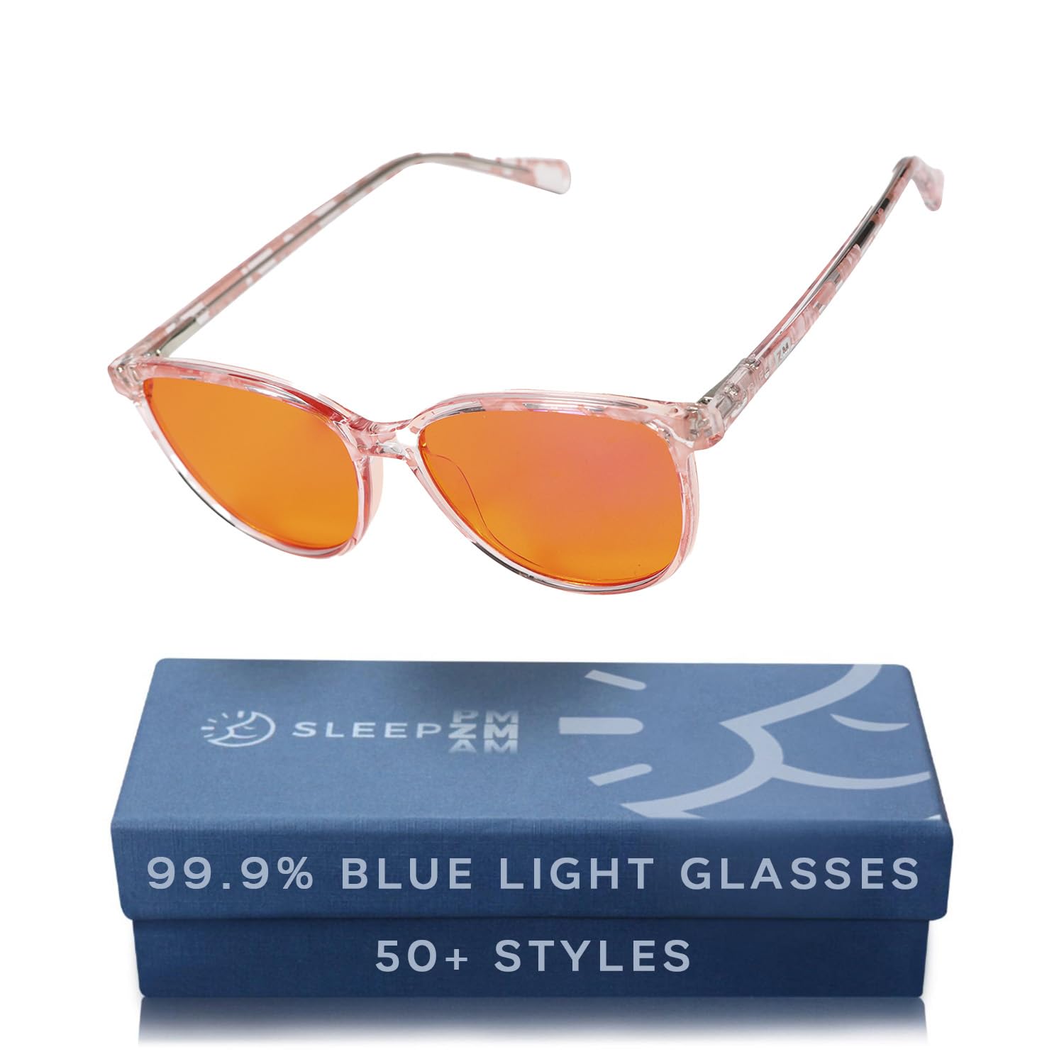 Sleep ZM Pink Warrior amber-lens glasses on desk reduce blue light for late-night work.