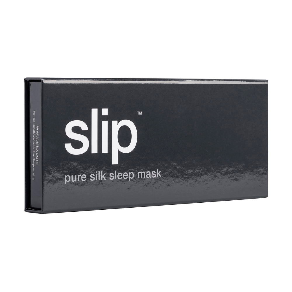 SLIP silk sleep mask beside travel case for on-the-go light protection.