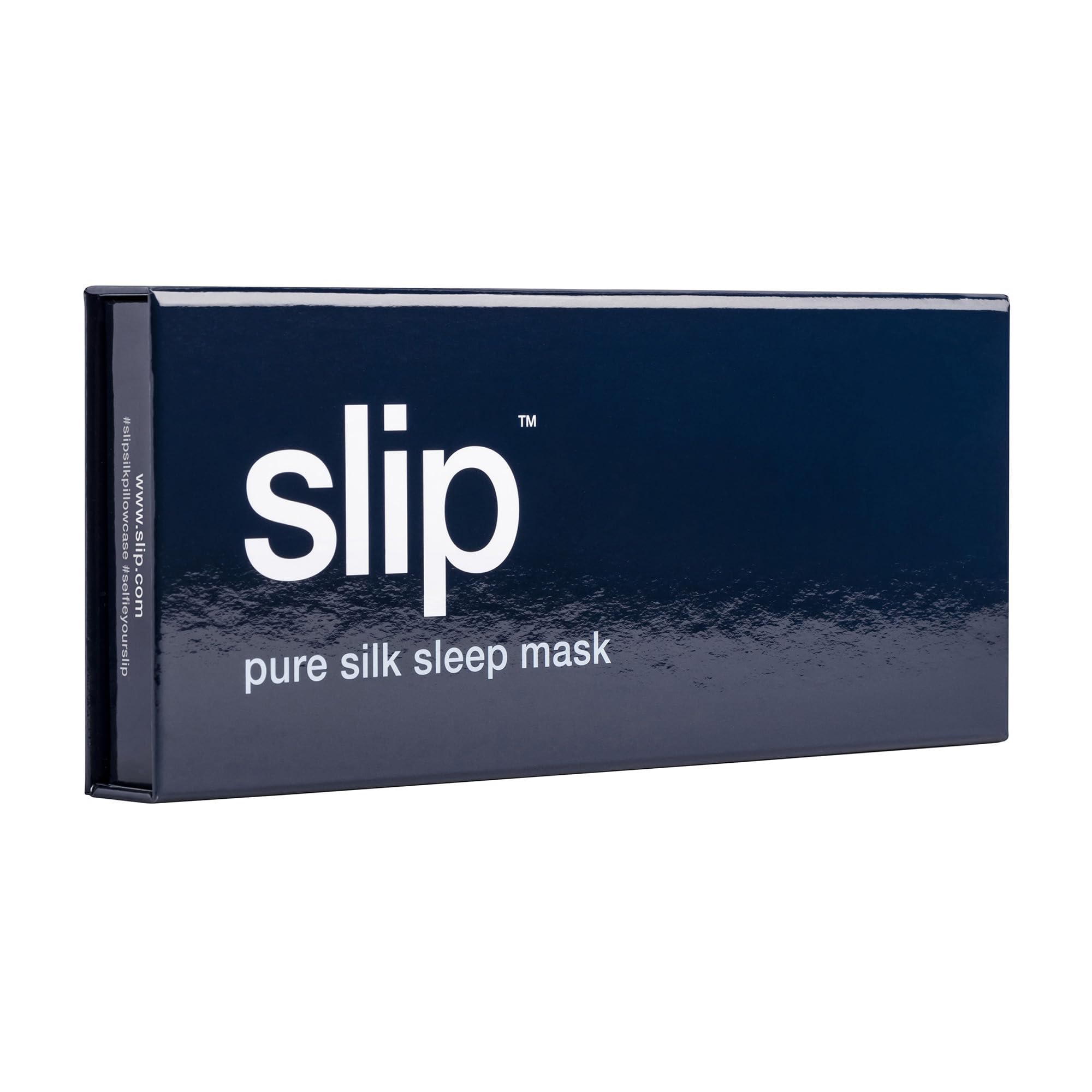 SLIP Pure Silk Sleep Mask Navy on a bedside surface highlighting hair-friendly design.