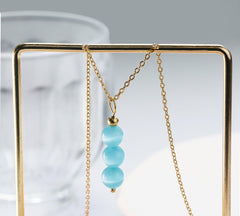 SmileBelle Aquamarine Necklace features natural gemstone beads with unique color variations.