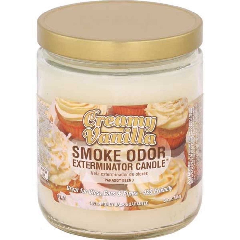 Smoke Odor Exterminator Creamy Vanilla 13oz candle burning, creating a cozy ambiance.