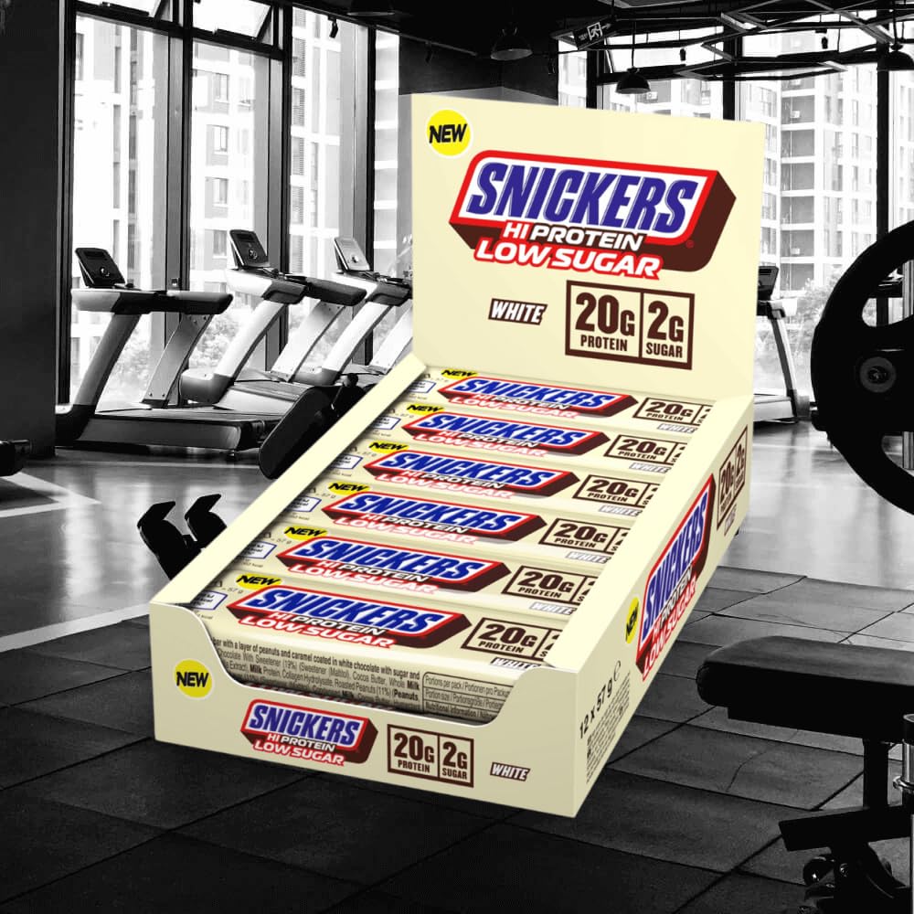 Snickers white chocolate bar close-up highlights creamy coating with protein-rich texture.