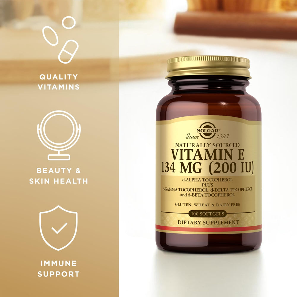Solgar Vitamin E 200 IU softgels poured from bottle for easy absorption.