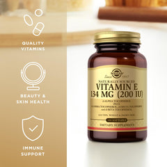 Solgar Vitamin E 200 IU softgels poured from bottle for easy absorption.