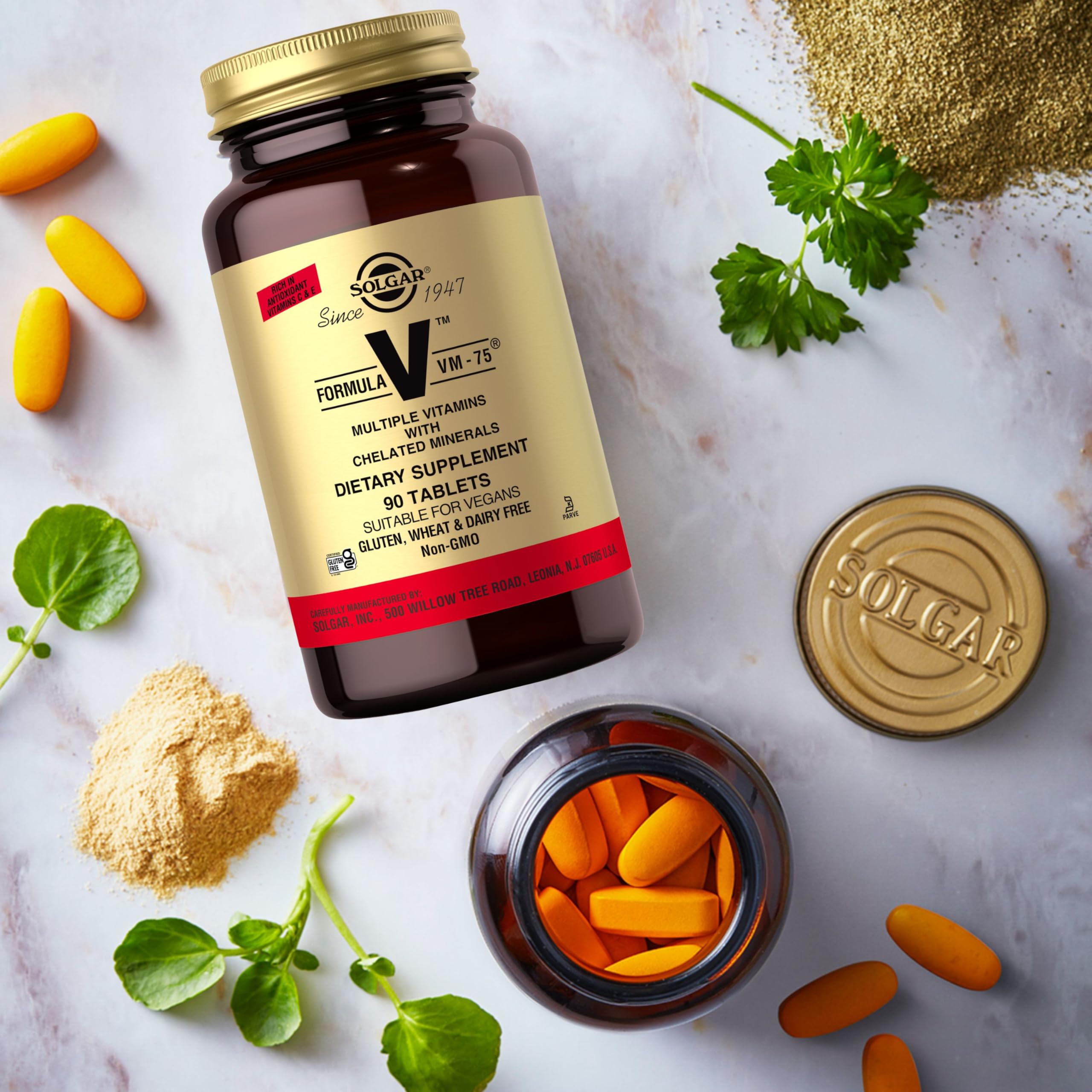 Solgar VM-75 tablets on a spoon, suggesting convenient daily use.