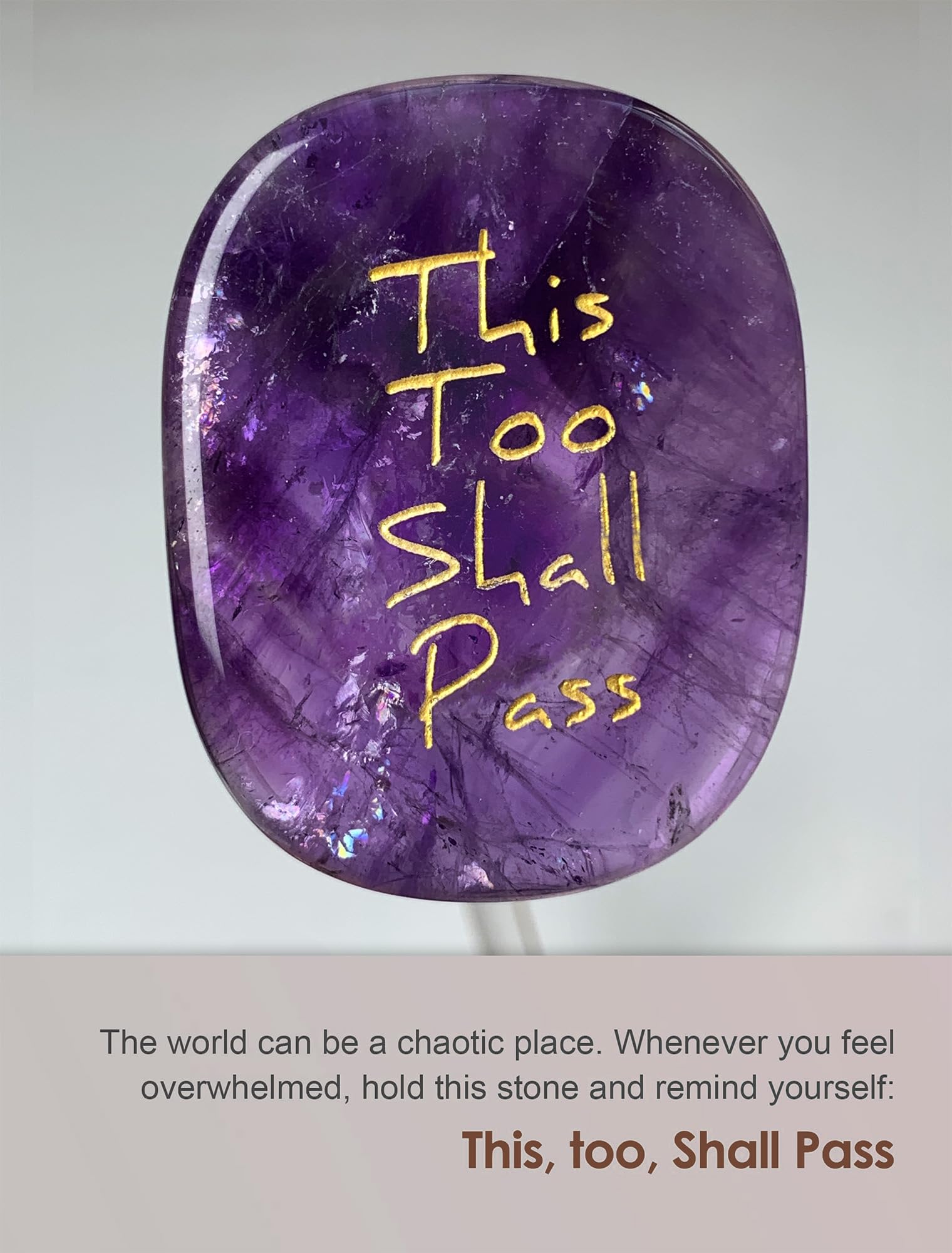 Close-up of carved This Too Shall Pass on amethyst