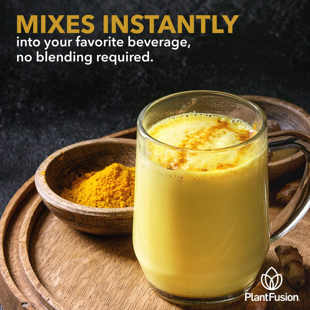 Chilled glass of turmeric-ginger drink with amber color.
