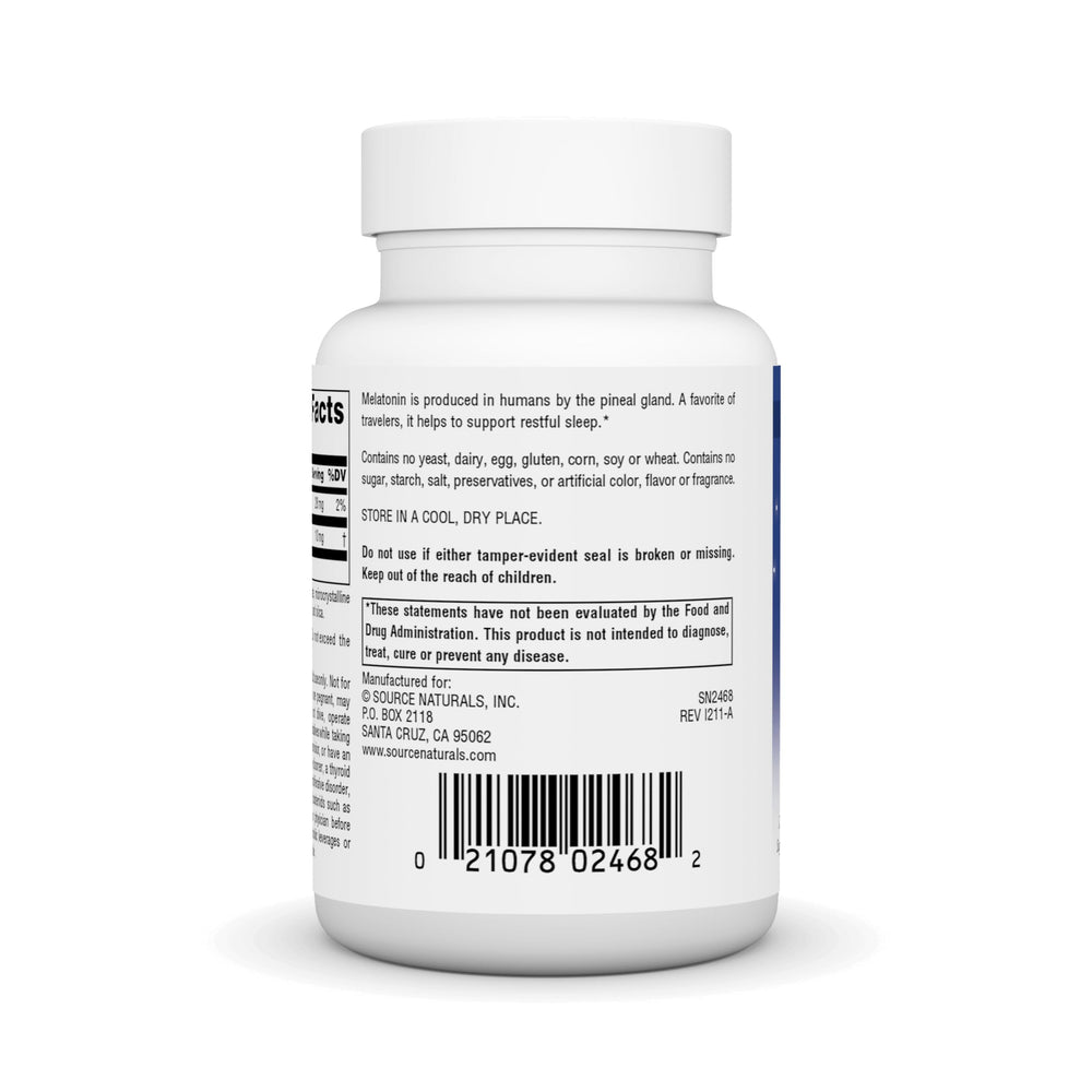 Hands holding melatonin tablet ready for bedtime routine.