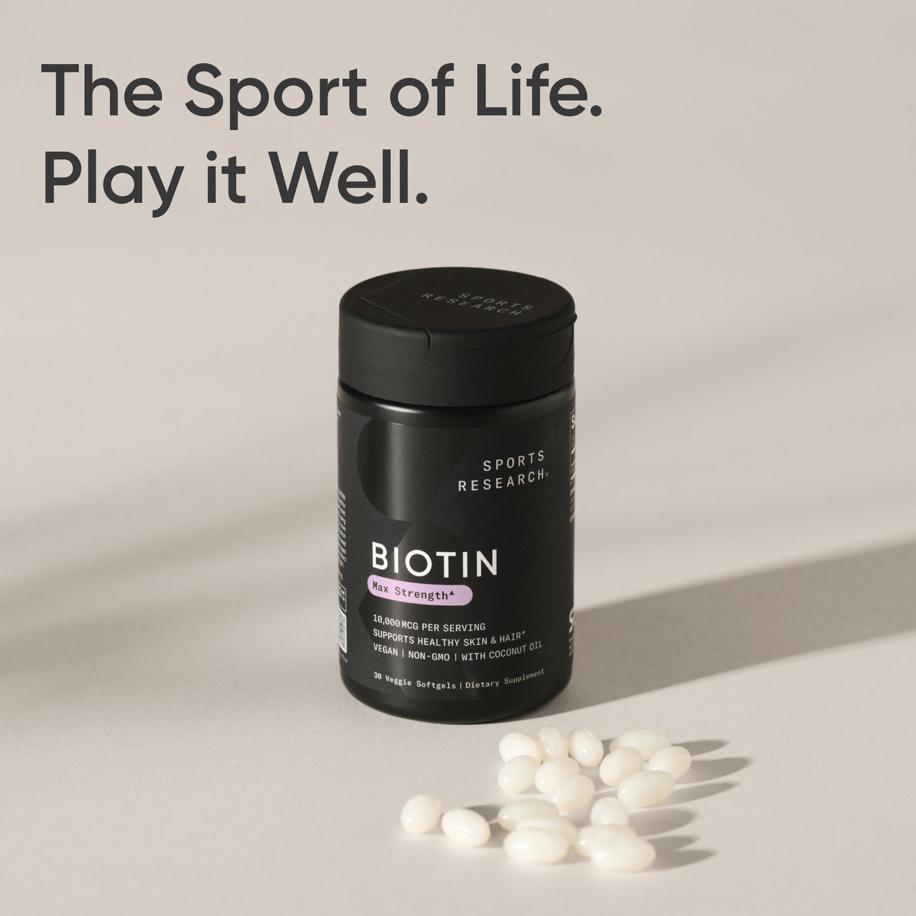 Sports Research Biotin bottle pouring into a glass for easy daily intake.