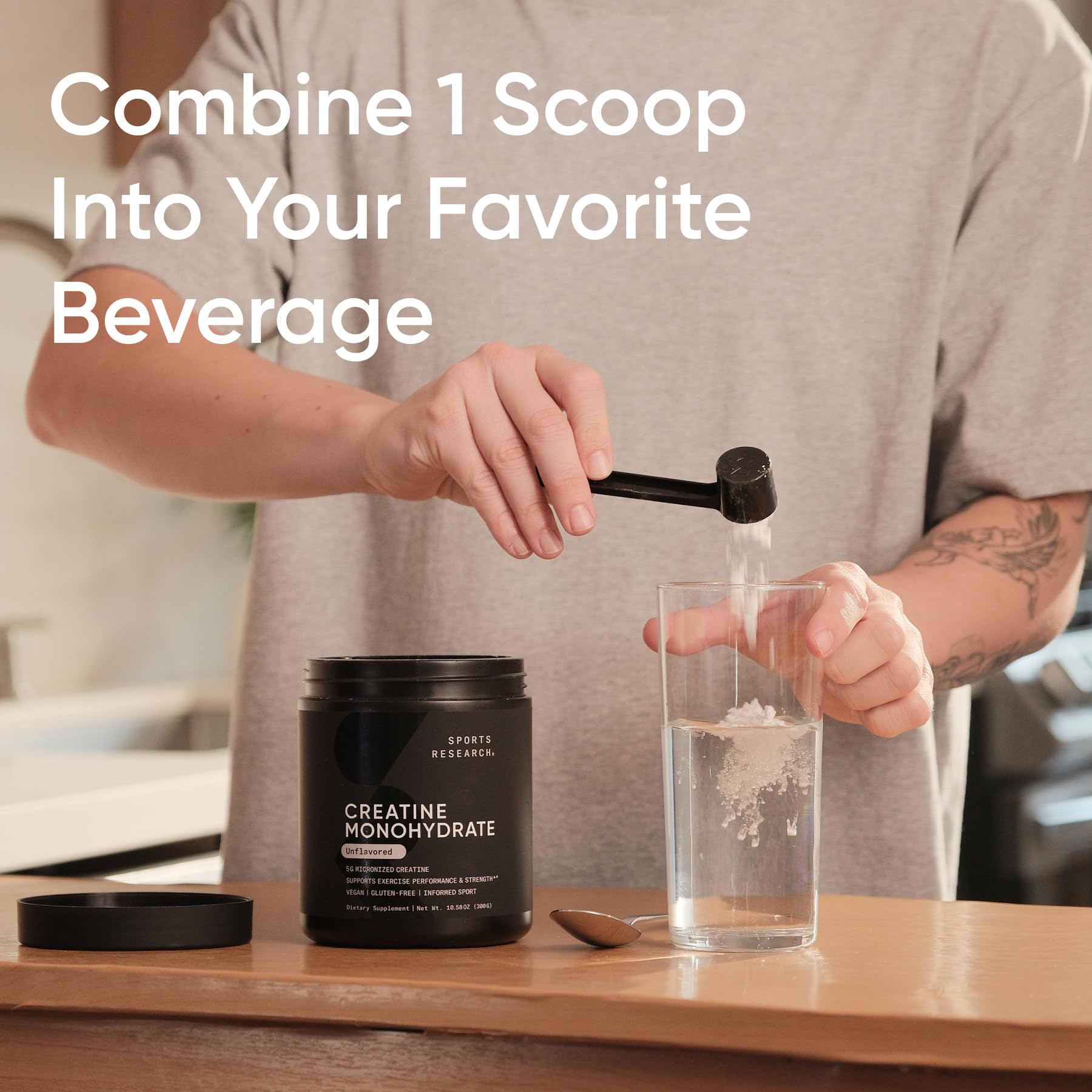 Sports Research Creatine Monohydrate powder dissolving quickly in water for easy post-workout mix.