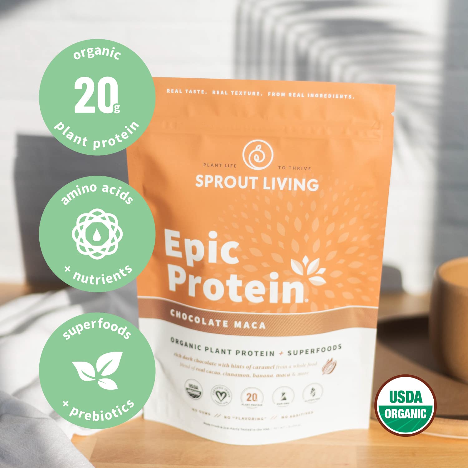 Kitchen setup featuring Sprout Living Epic Protein Chocolate Maca powder bottle.
